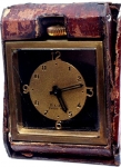 An 8 Days Swiss Made Travelling Clock Enclosed In Leather...