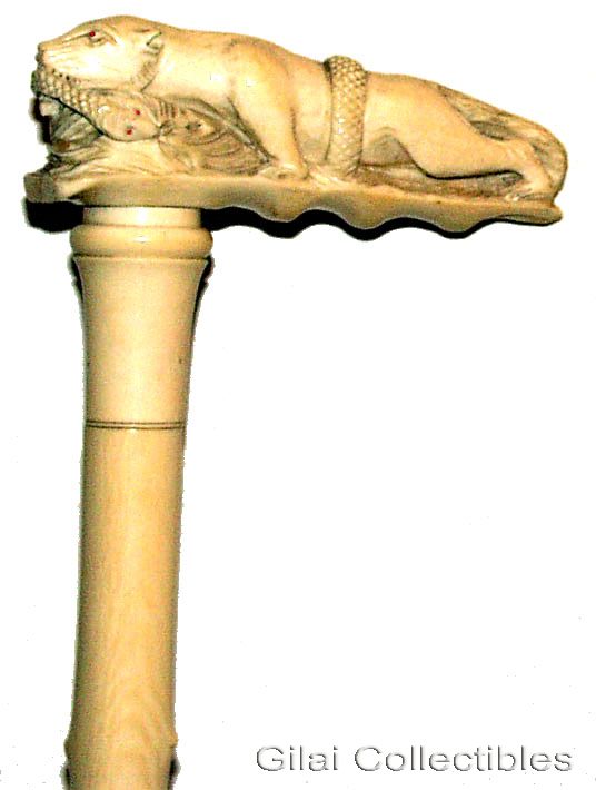 A 19th Century French Cane Made Completely Of Ivory With Carved Leopard Devouring A Snake. - click to enlarge.