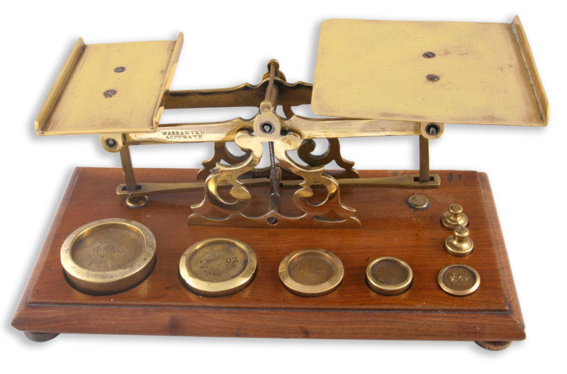 Brass Postal Scales with 7 weights on a Mahogany Base - click to enlarge.
